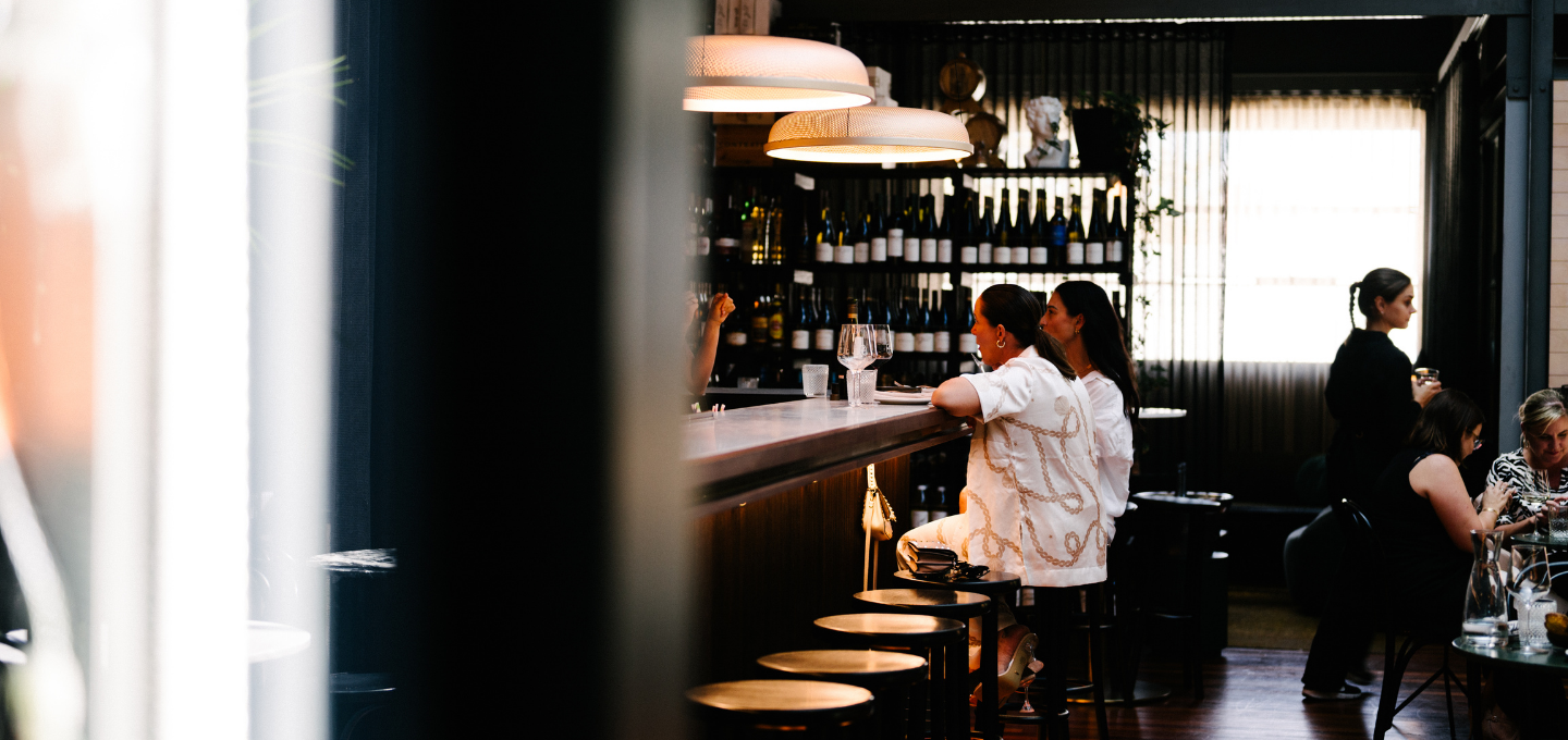 Wine bar atmosphere at Cherubino City Cellar with guests seated at the bar