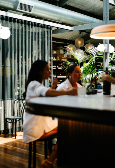Wine bar atmosphere at Cherubino City Cellar with guests seated at the bar
