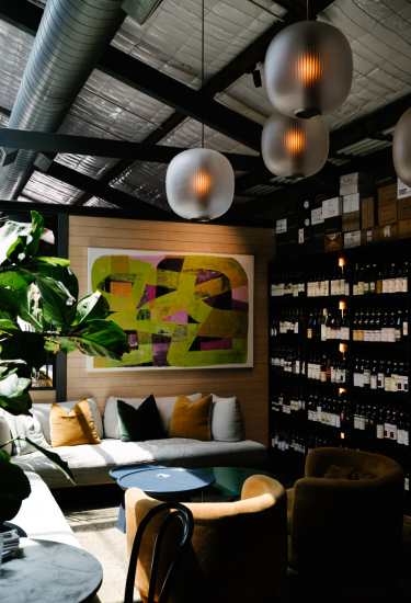 Interior lounge at Cherubino City Cellar featuring contemporary artwork and wine collection