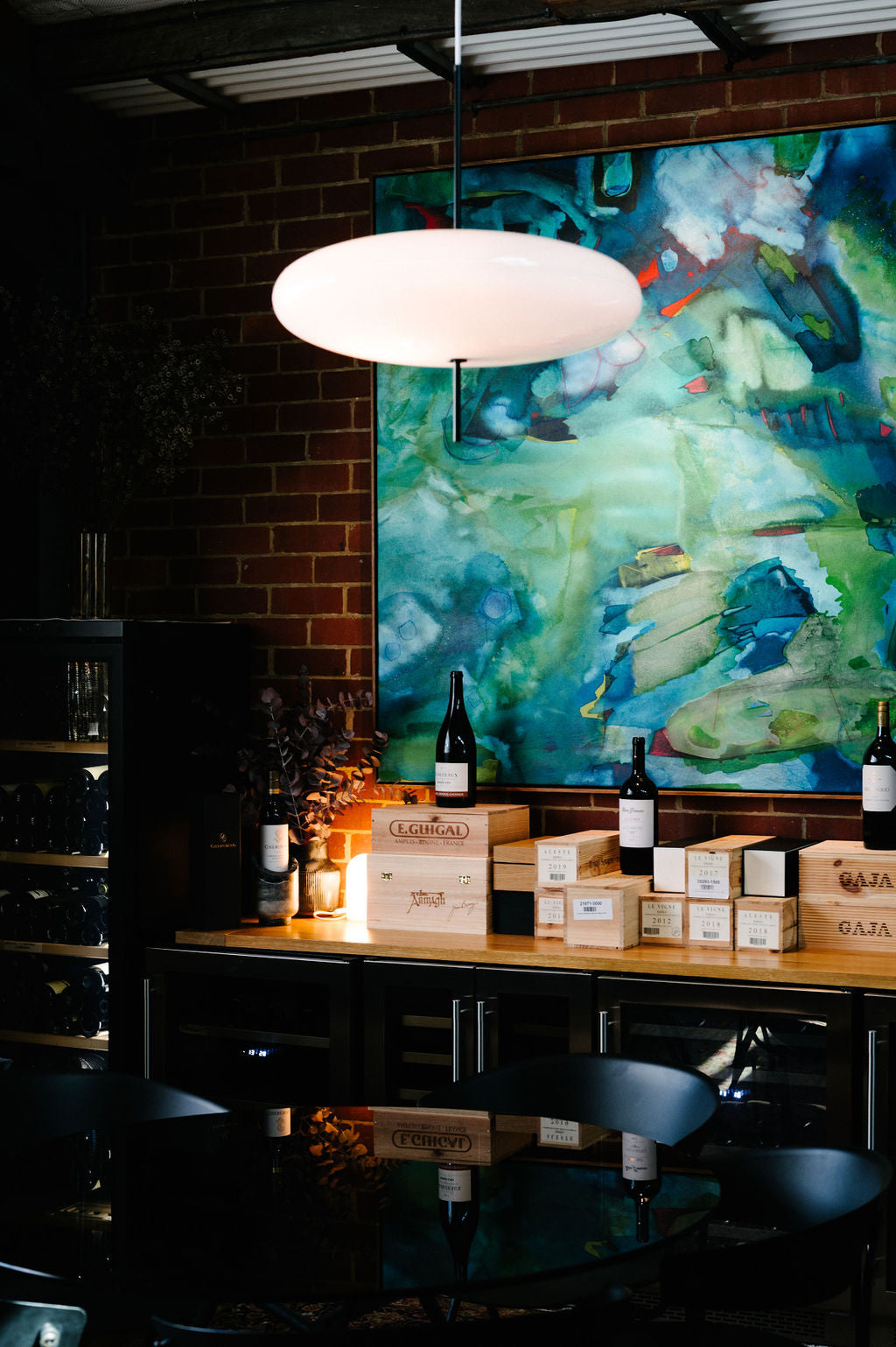 Interior detail of Cherubino City Cellar wine bar in Subiaco, Perth, featuring curated wine display and contemporary artwork