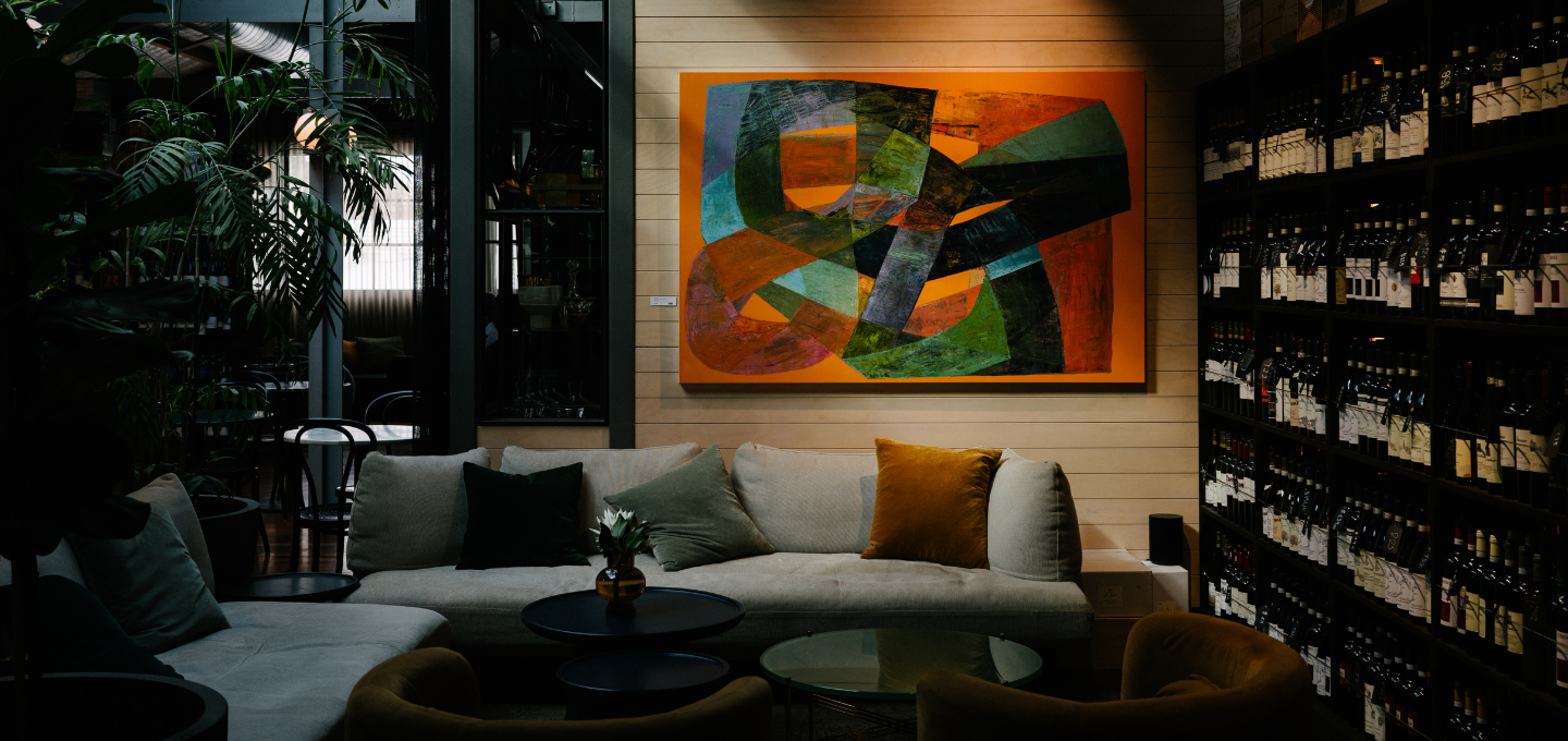Interior lounge at Cherubino City Cellar featuring contemporary artwork and wine collection