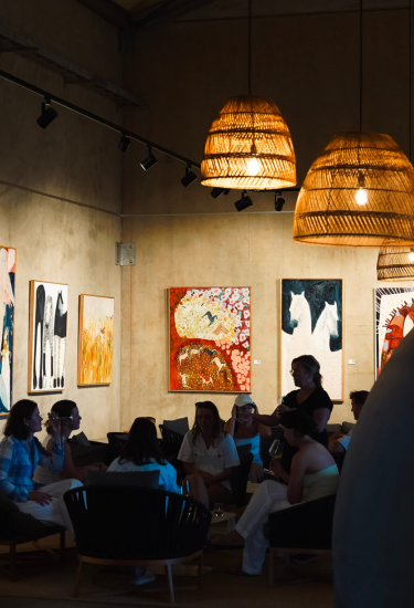 Art gallery with attendees and framed artworks on the wall