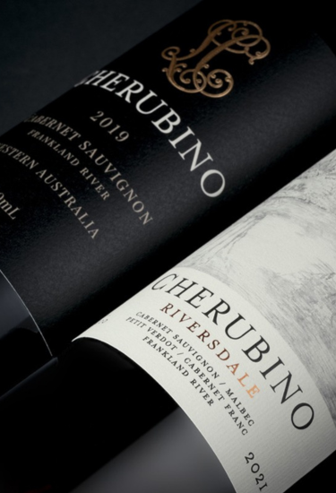 Two bottles of Cherubino wine with black and white labels on a dark background