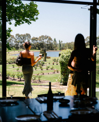 Guests enjoying a lakeside view from Masseria Restaurant overlooking the rose garden