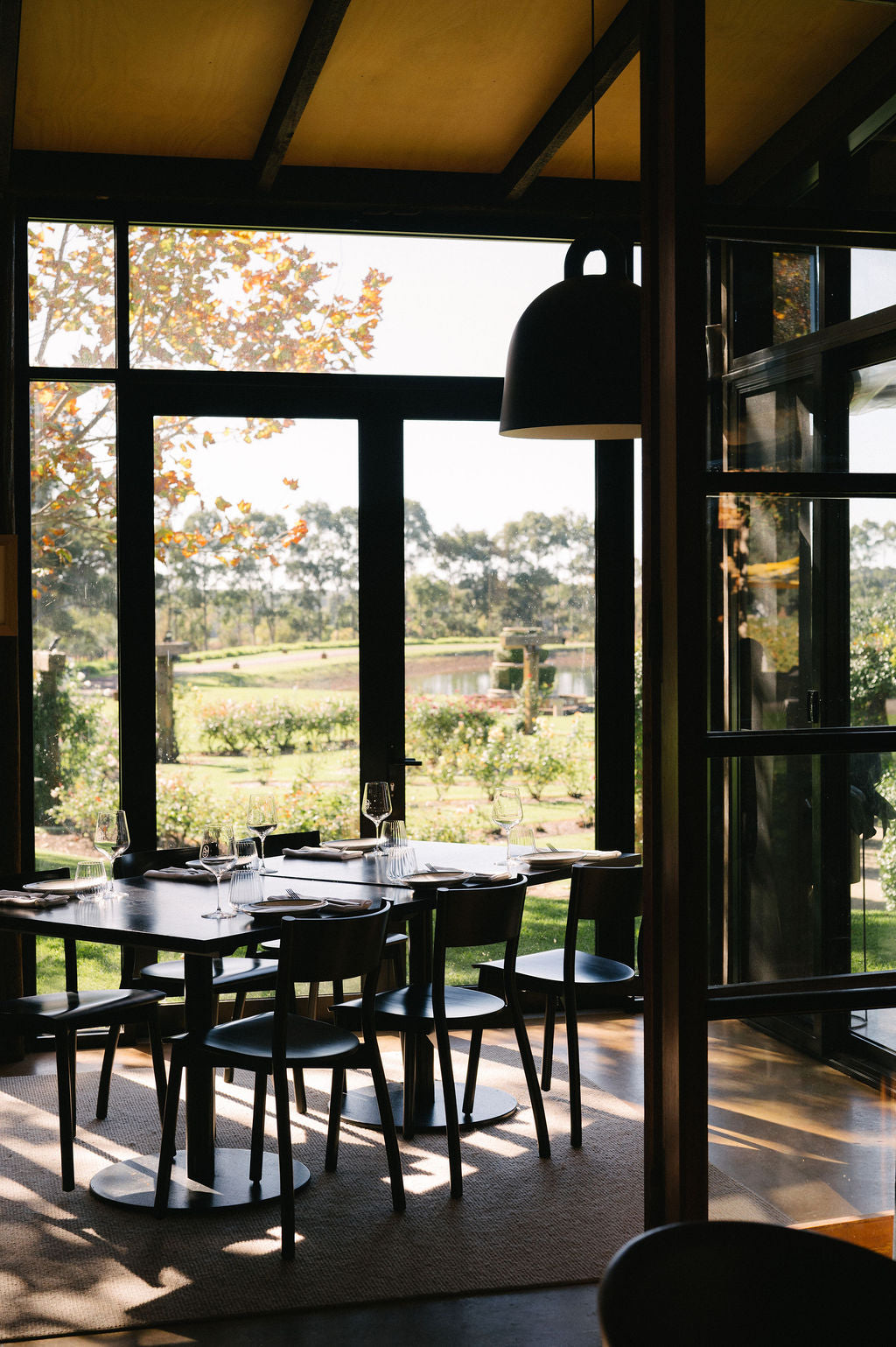 Dining area with large windows overlooking a scenic landscape