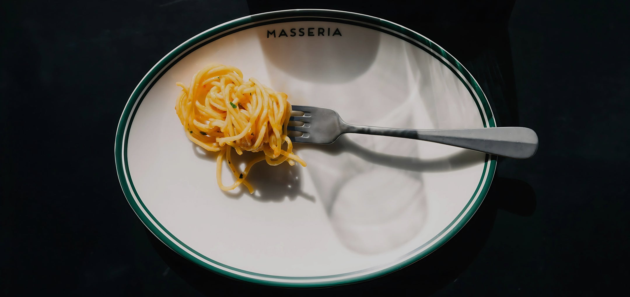 A forkful of fresh pasta served on a Masseria plate