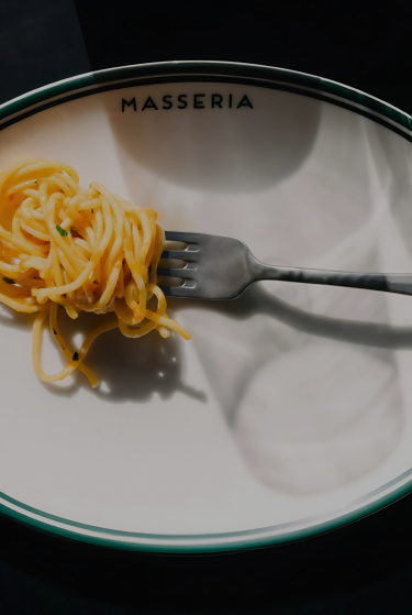 A forkful of fresh pasta served on a Masseria plate