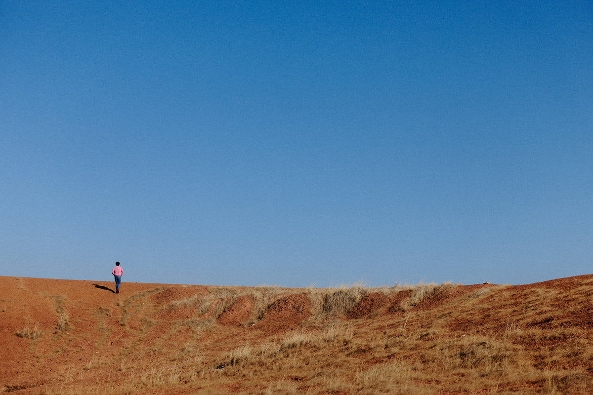 Larry Cherubino standing on red earth, Frankland River vineyard