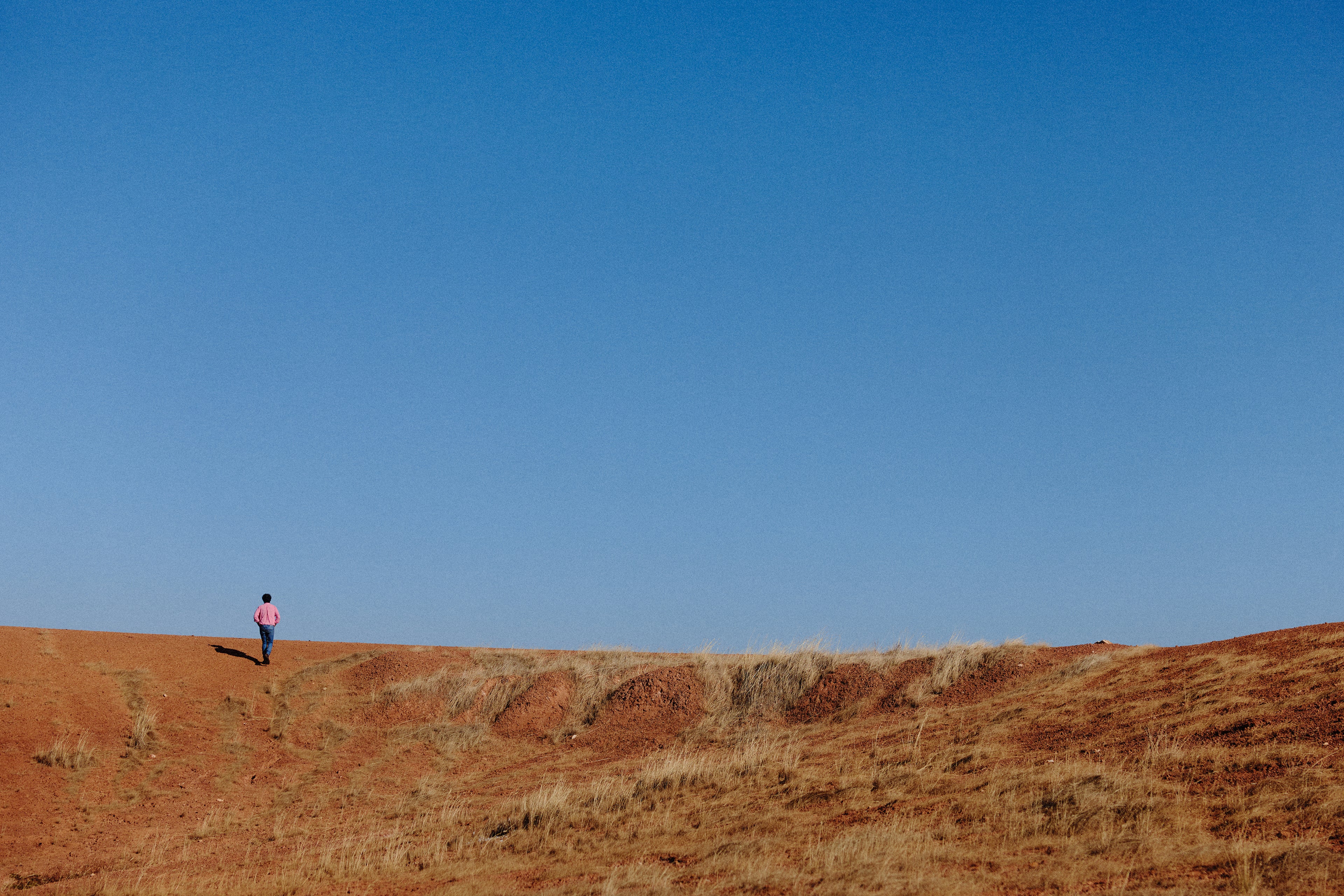 Larry Cherubino standing on red earth, Frankland River vineyard